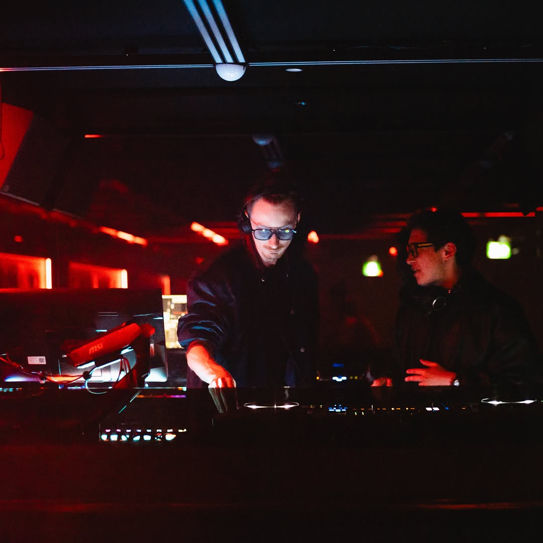 MIOKASTA leading a live set while the second DJ stands side-on