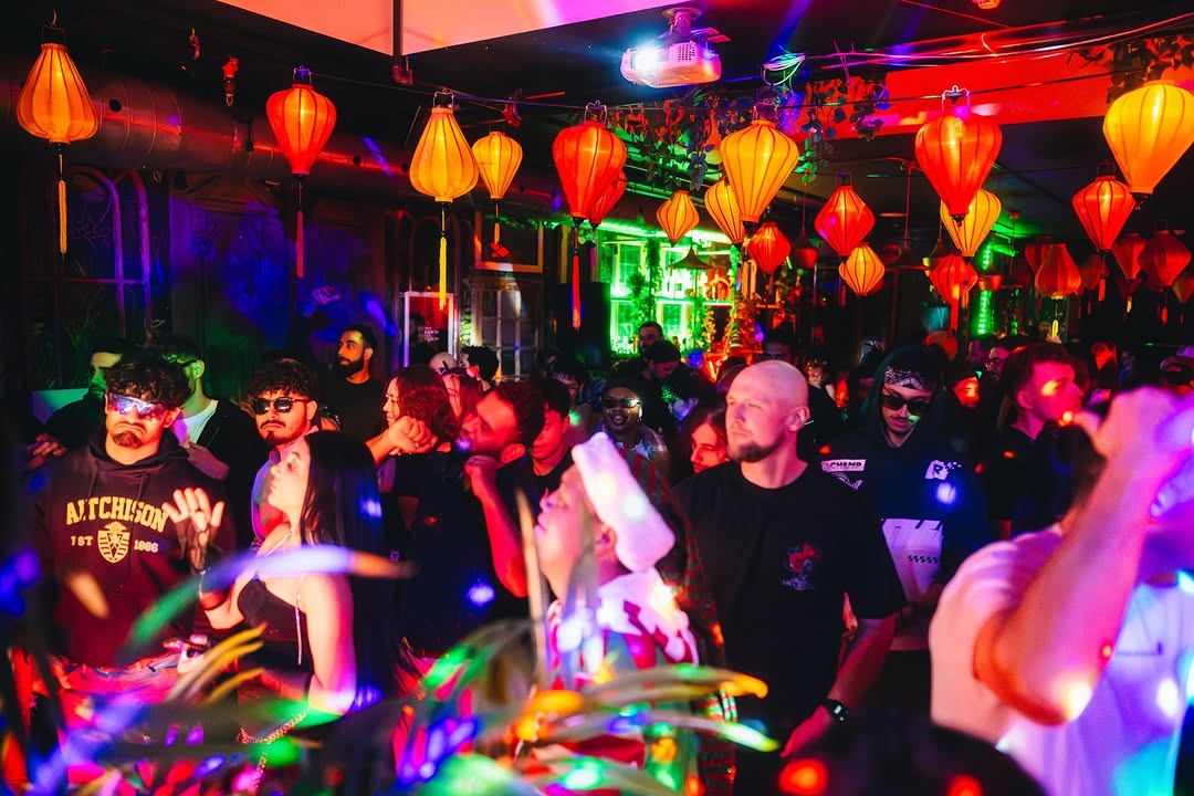 Dancefloor beneath warm lanterns during a MIOKASTA set